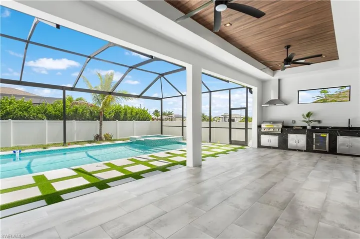 Step outside to your PRIVATE OASIS w/ HEATED SALTWATER POOL (35 x 14 ft) & SPA, surrounded by high-grade pavers & ARTIFICIAL GRASS inside SCREENED LANAI & LUSH LANDSCAPING within FENCED PROPERTY.