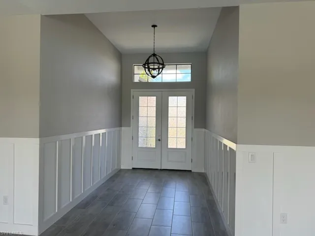 Entryway with a chandelier and a high ceiling