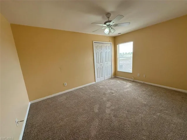 3rd Bedroom with carpet floors, baseboards, and a closet