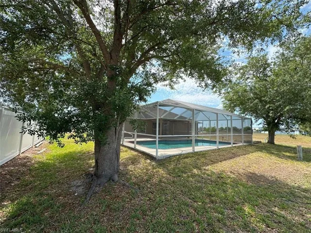 View of yard featuring an outdoor pool and a lanai