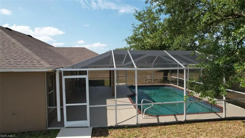 Outdoor pool with a patio and a lanai