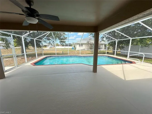 Swimming pool featuring a patio area, a lanai, and ceiling fan