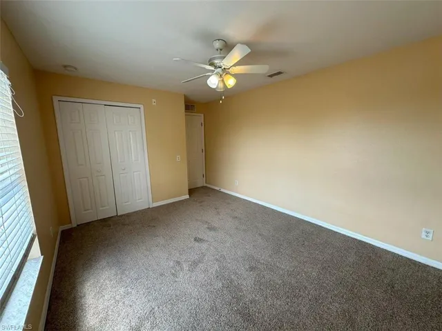 2nd Bedroom featuring carpet flooring, a closet, baseboards, and ceiling fan