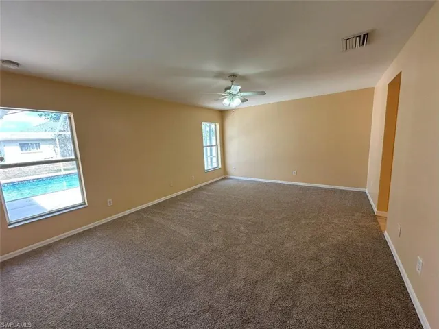 Master Bedroom with a ceiling fan, carpet floors, baseboards, and a smoke detector