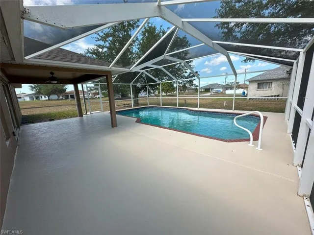 Outdoor pool with a patio area and a lanai