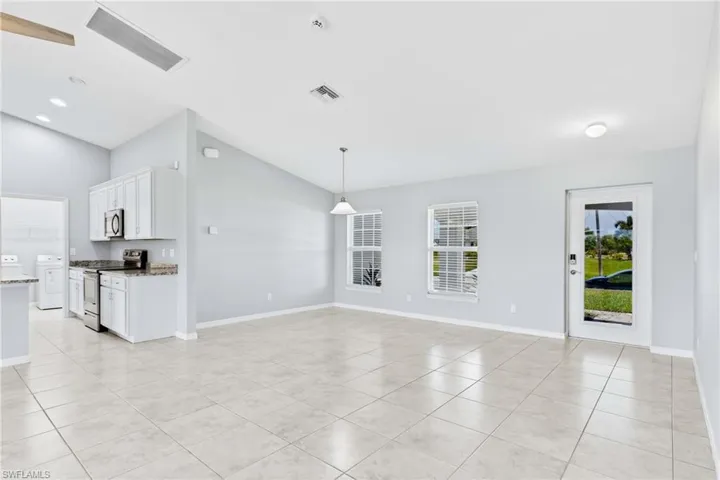 An inviting foyer welcomes you with soaring ceilings and abundant natural light, creating a warm first impression.
