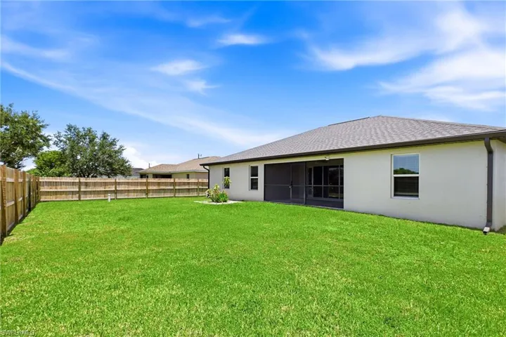 The expansive backyard offers endless opportunities to create your own outdoor paradise, with plenty of room for a custom pool and tropical landscaping.