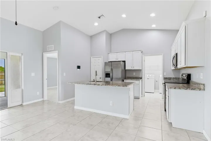 The heart of the home features ample cabinetry, generous counter space, and a functional layout perfect for preparing meals and gathering with family and friends.