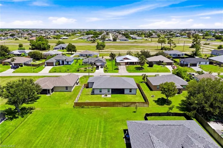 A stunning aerial view showcases the expansive fenced backyard and endless possibilities for creating your dream outdoor retreat.