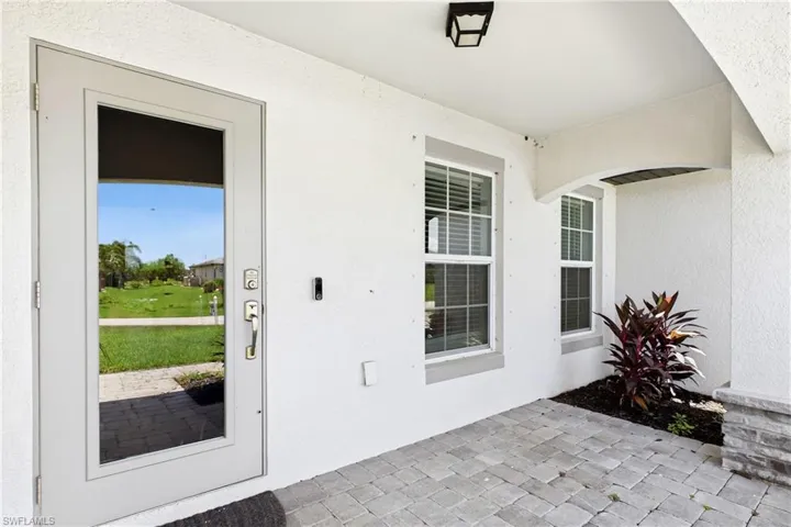 A welcoming covered entry invites you inside, setting the stage for the warmth and comfort found throughout the home.