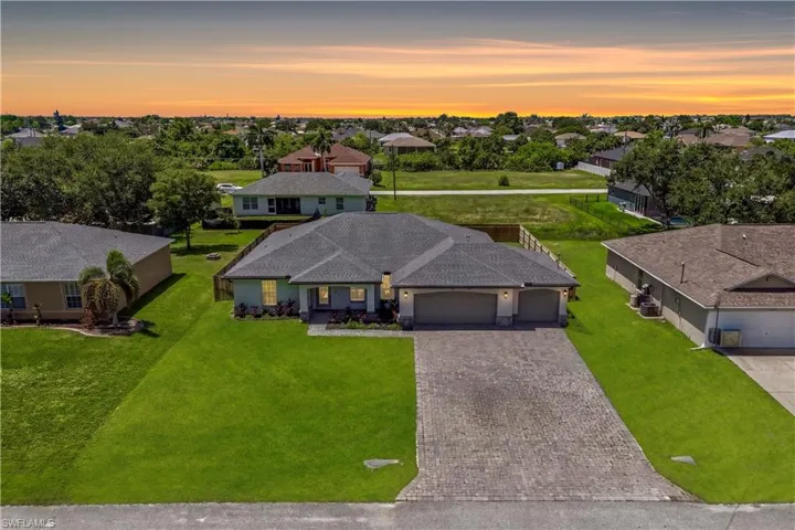 Welcome home to this beautifully maintained 2021 residence featuring timeless curb appeal, a spacious three-car garage, and lush tropical landscaping.