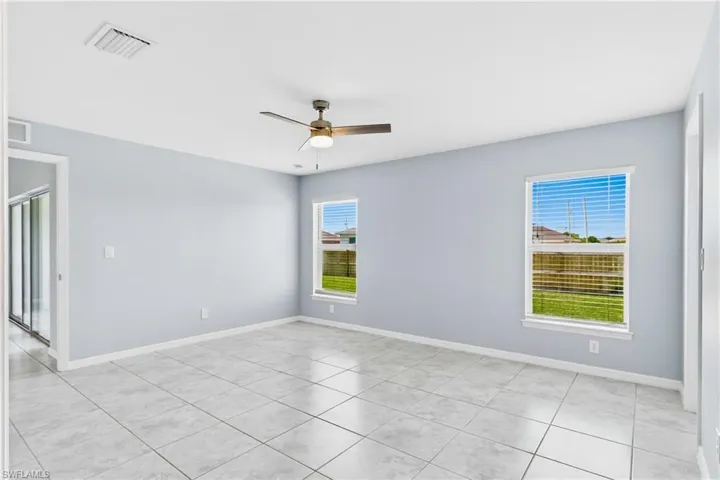 The generous primary suite offers ample space for a king-size bedroom set while maintaining a peaceful, relaxing feel.