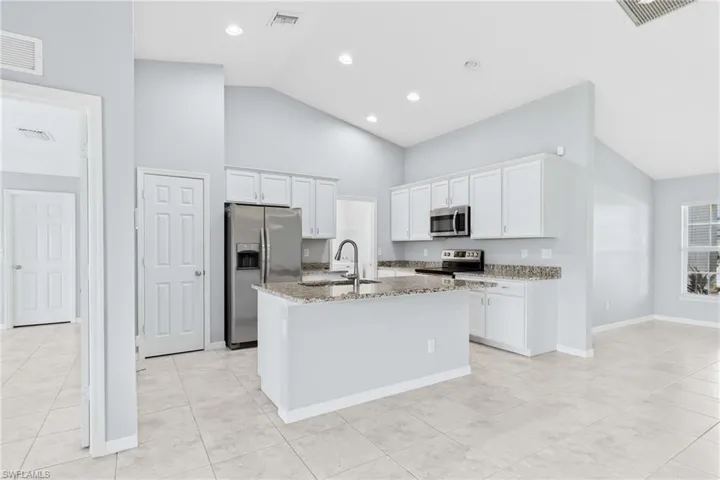 A spacious breakfast bar provides the perfect place for casual dining, morning coffee, or entertaining guests.