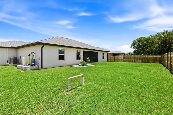 The fenced backyard provides a private retreat with endless possibilities for outdoor living, play, gardening, or future enhancements.