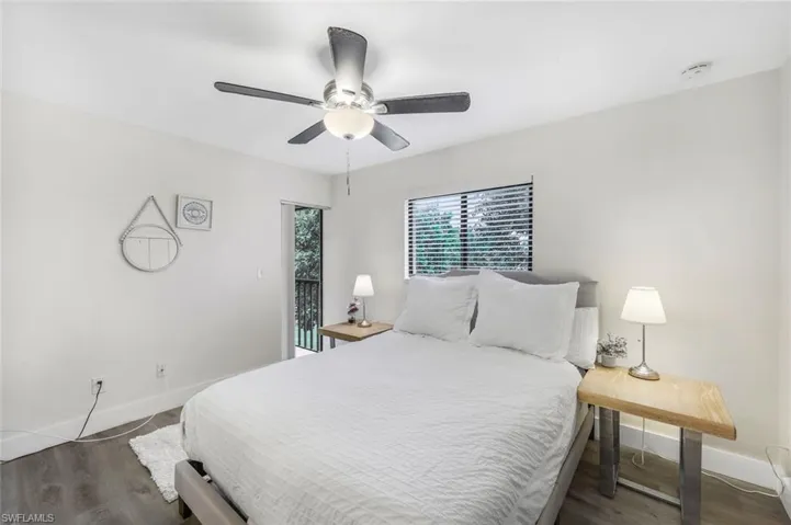 Bedroom featuring baseboards, wood finished floors, and ceiling fan