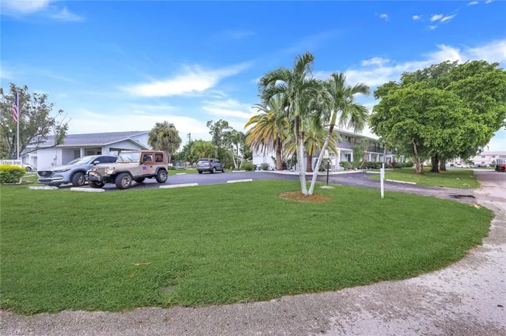 View of green lawn with driveway