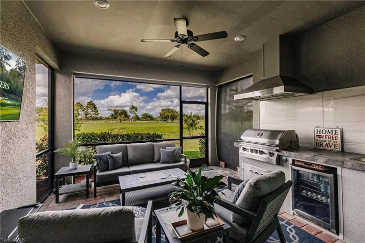 Extended lanai with outdoor kitchen, privacy shades and a ceiling fan