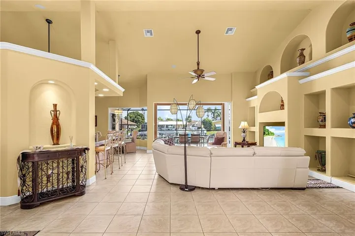 Living area featuring built in shelves and vaulted ceilings