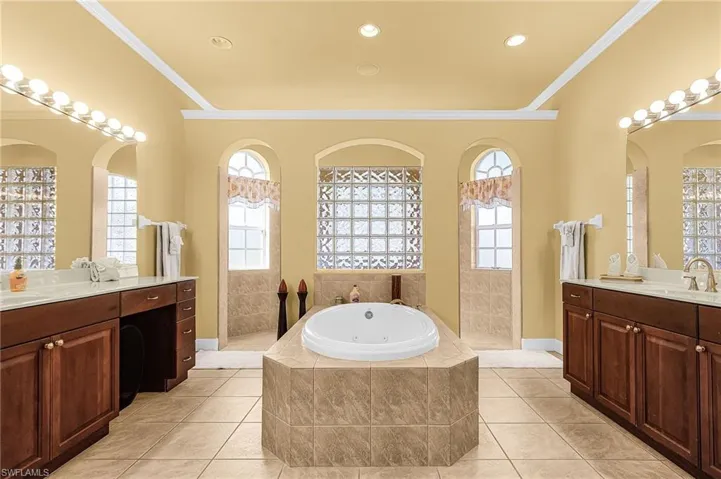 Primary Bathroom w/ jetted soaking tub, dual vanities and walk through shower
