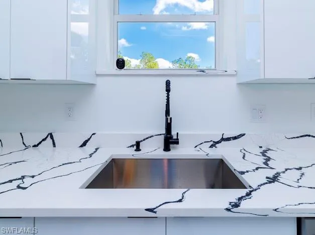 Kitchen view of white cabinetry and modern cabinets