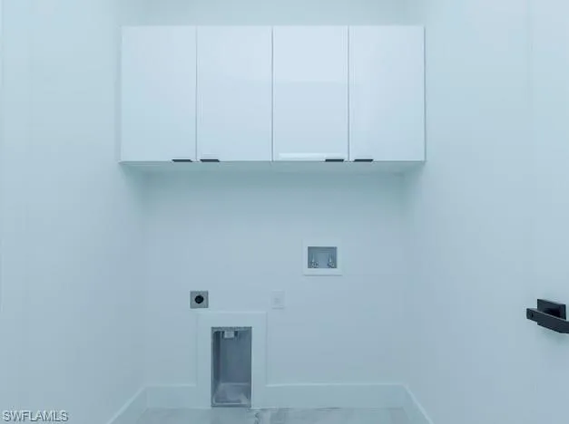Washroom featuring hookup for a washing machine, cabinet space, and hookup for an electric dryer