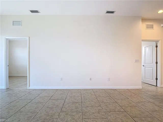 Spare room featuring baseboards and visible vents