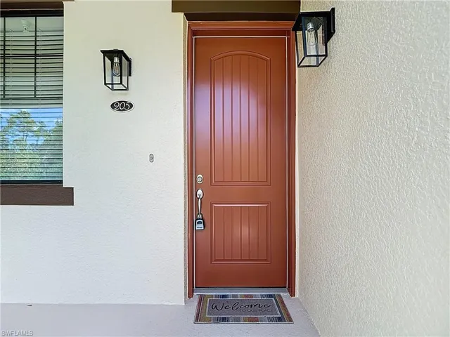 Doorway to property with stucco siding