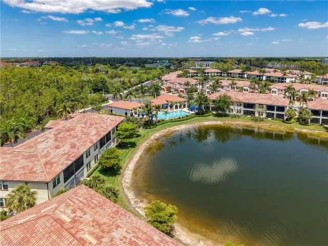 Birds eye view of property with a water view