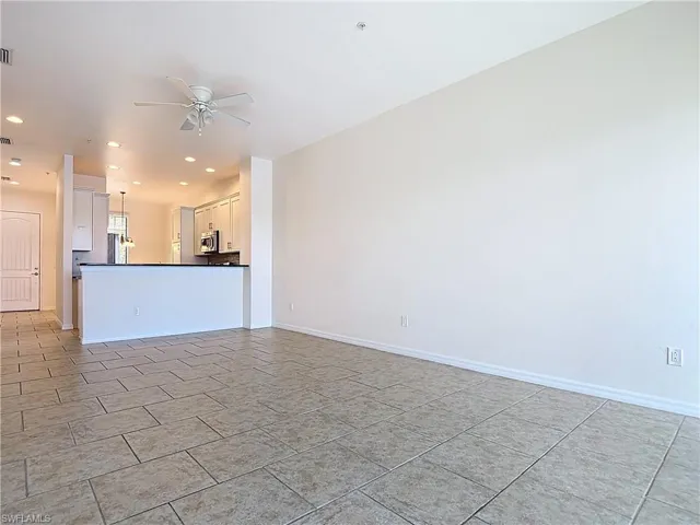 Unfurnished living room featuring baseboards, recessed lighting, and ceiling fan