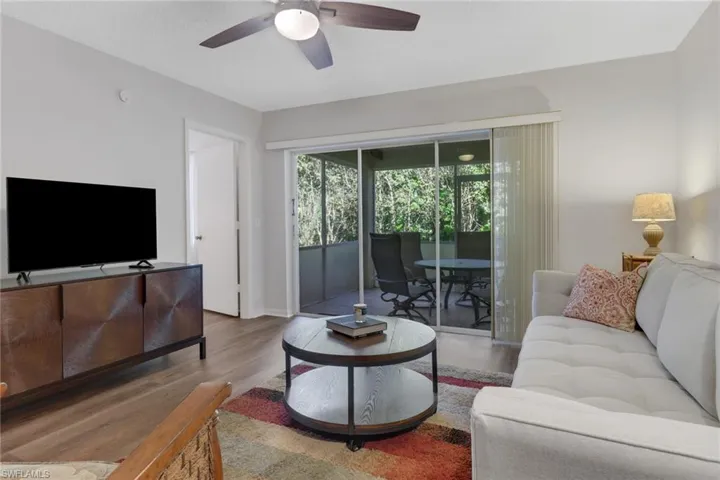 Living room with ceiling fan and wood-type flooring