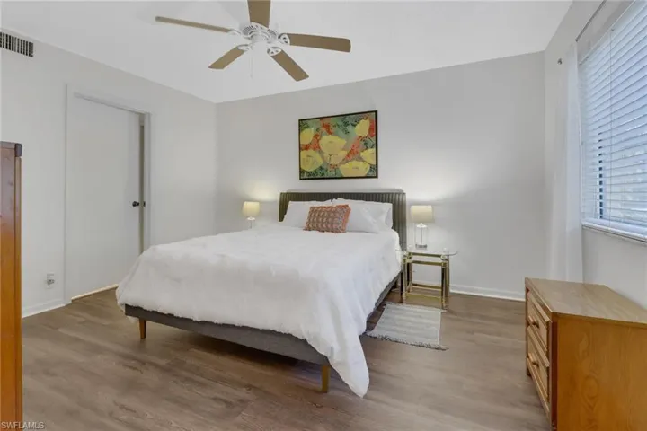 Bedroom featuring ceiling fan and wood-type flooring