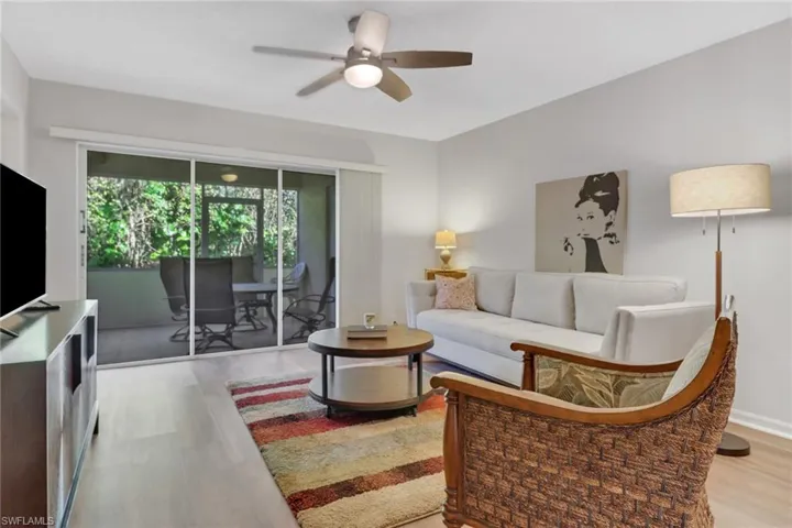 Living room featuring light hardwood / wood-style floors and ceiling fan