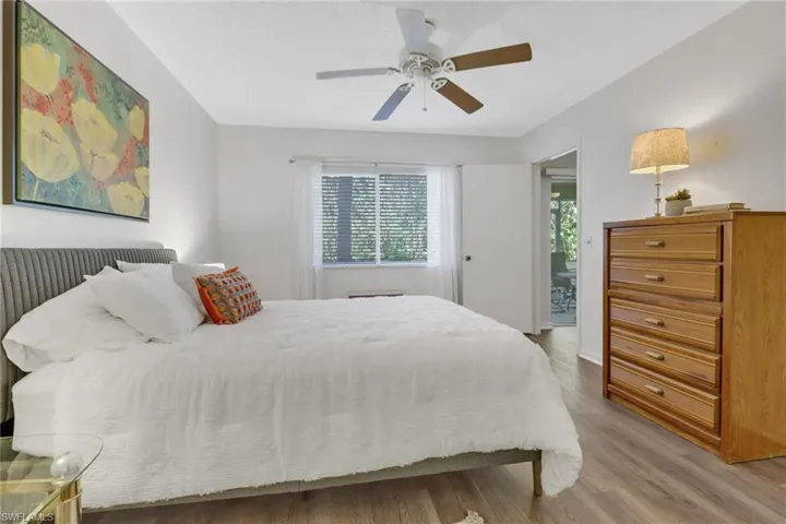 Bedroom featuring ceiling fan and hardwood / wood-style flooring