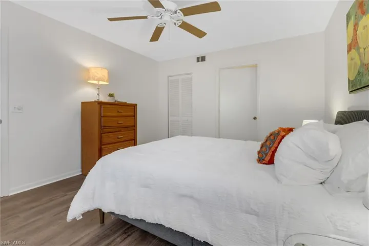 Bedroom featuring dark hardwood / wood-style flooring, a closet, and ceiling fan
