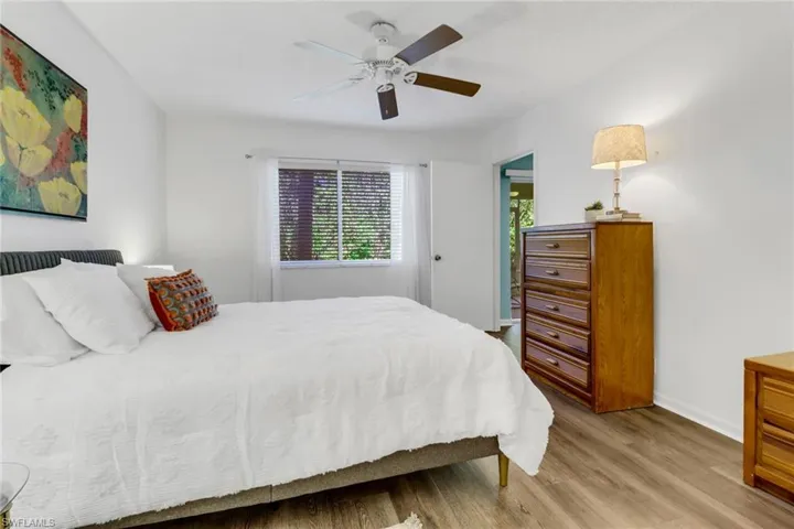 Bedroom with ceiling fan and wood-type flooring