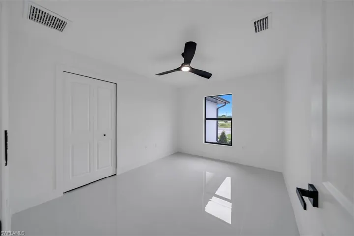 Unfurnished bedroom with a closet and a ceiling fan