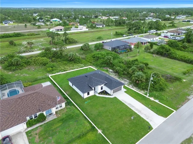 Aerial view of residential area featuring property boundaries highlighted and a tree filled landscape