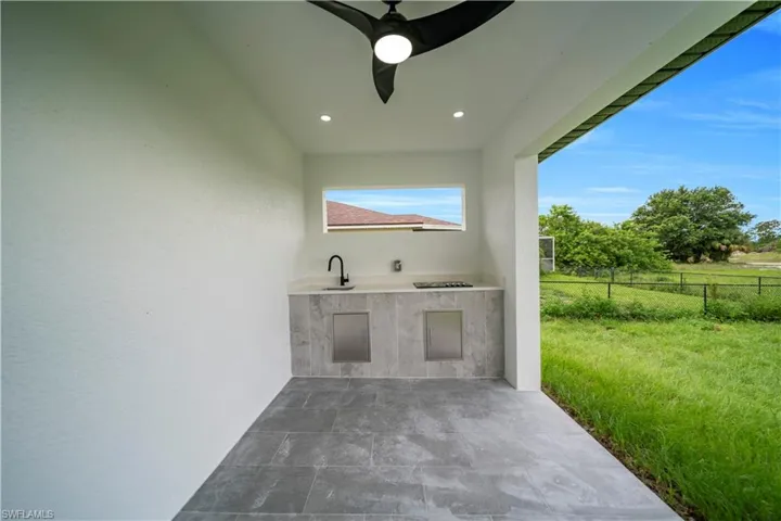 View of patio / terrace with area for grilling and a ceiling fan