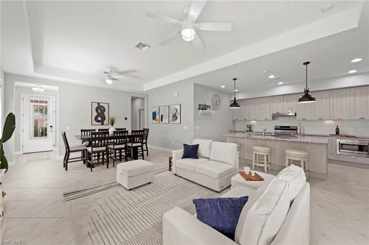 OPEN FLOOR PLAN with TILE FLOOR and NEUTRAL DECOR. NEW CEILING FANS (2017), NEW KITCHEN PENDANTS (2023), NEW ECOBEE THERMOSTAT (2024)