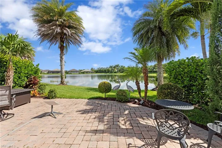 Paver lanai with a water view. NEW EXTENDED PAVER LANAI (2021), NEW LANDSCAPING (2021), NEW GAS GRILL (2023)