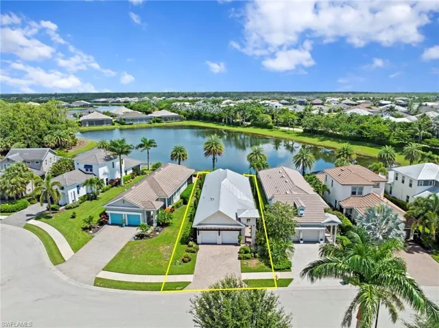 The beautifully landscaped home has concrete block construction with charming architectural details and a stunning view of the lake. NEW LANDSCAPING (2021), NEW RING VIDEO DOOR BELL (2024), NEW EXTERIOR SECURITY CAMERAS (2025), and NEW GARAGE DOOR KEYPADS (2025)