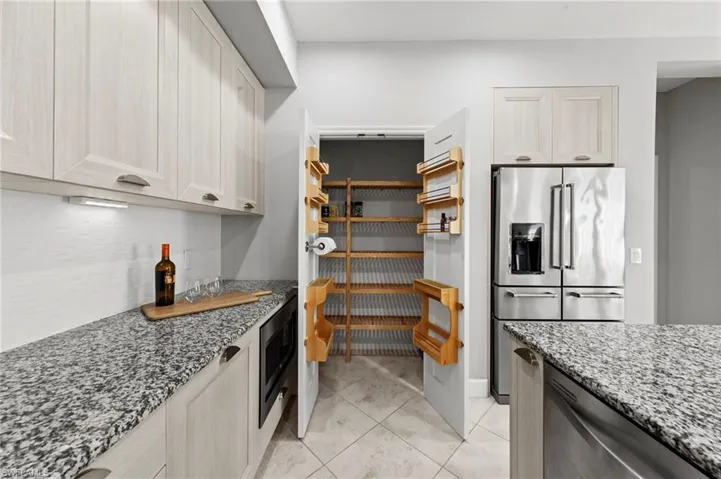 Walk-in pantry with custom storage and shelving. NEW BACKSPLASH (2019), NEW APPLIANCES (2023)