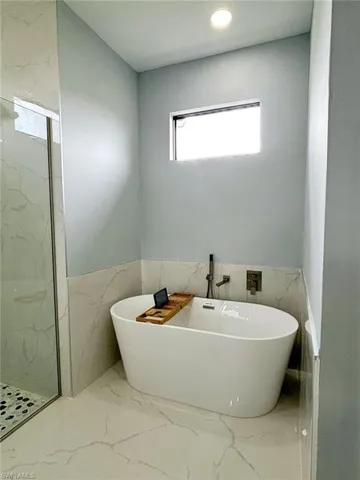 Bathroom with tile walls and tile patterned flooring