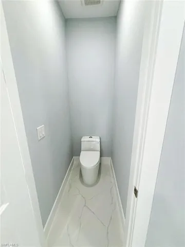 Bathroom featuring toilet and tile patterned floors