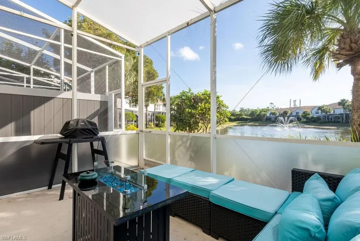 Sunroom featuring a water view