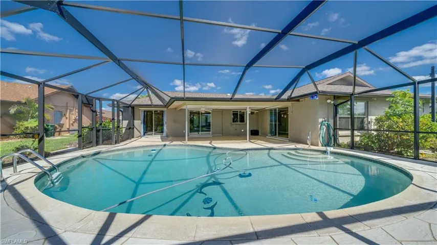 View of swimming pool featuring a patio and a lanai