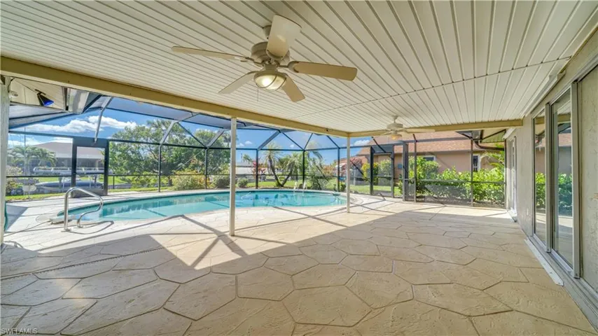View of pool with ceiling fan