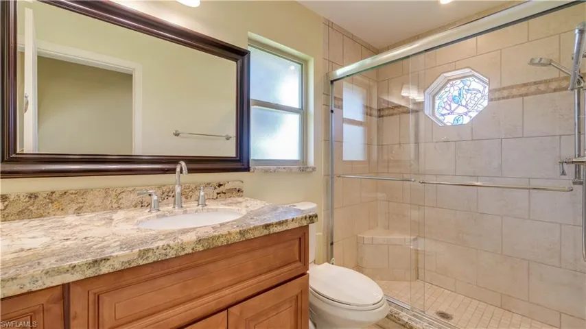 Guest bathroom with an enclosed shower, and vanity