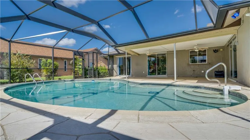 View of pool with a patio, a lanai, and ceiling fan