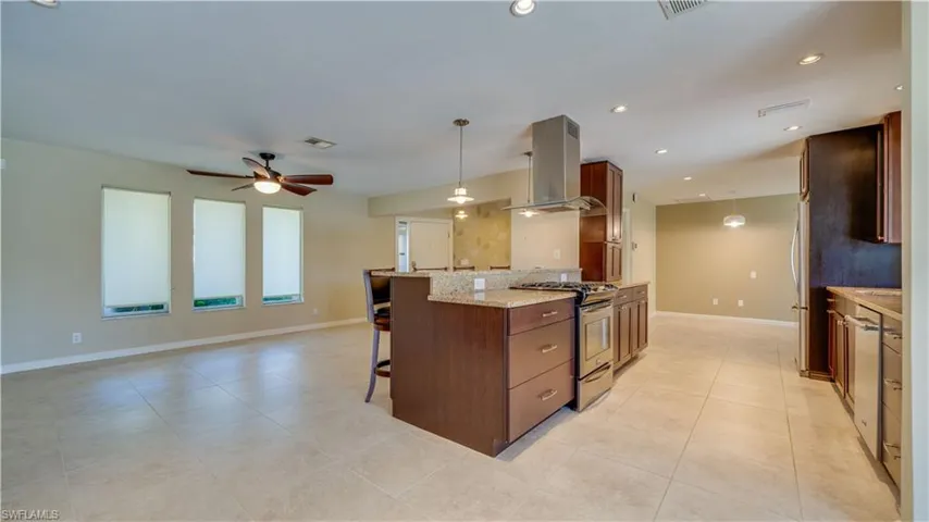 Kitchen with stainless steel appliances, island exhaust hood, granite countertops